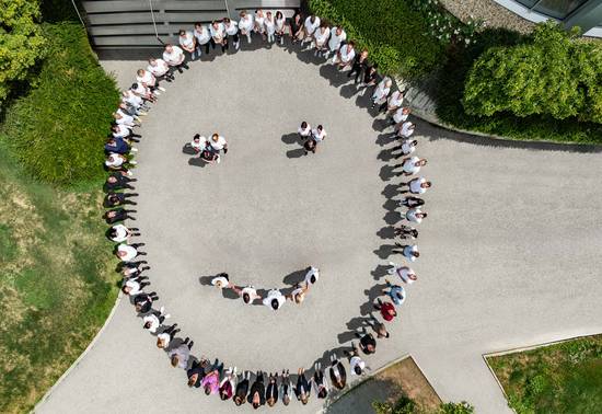 REDUCE Mitarbeiter formen einen lachenden Smiley